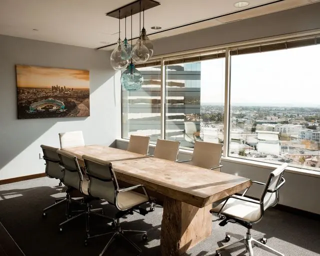 Modern office with wooden table and city view.